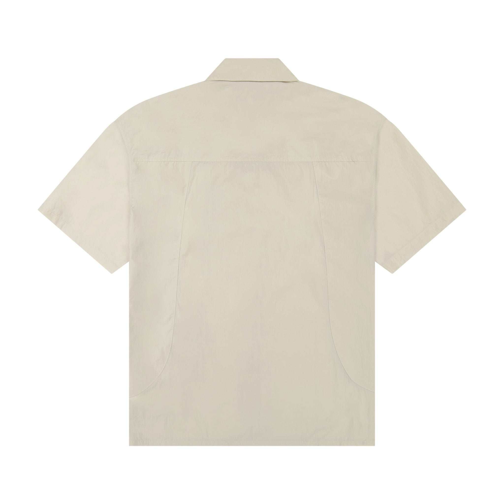 Boone Shirt made of recycled nylon with 3D pleating, glued collar, engraved silver buttons, and leather-metal logo patch, designed for modern minimalism and comfort.